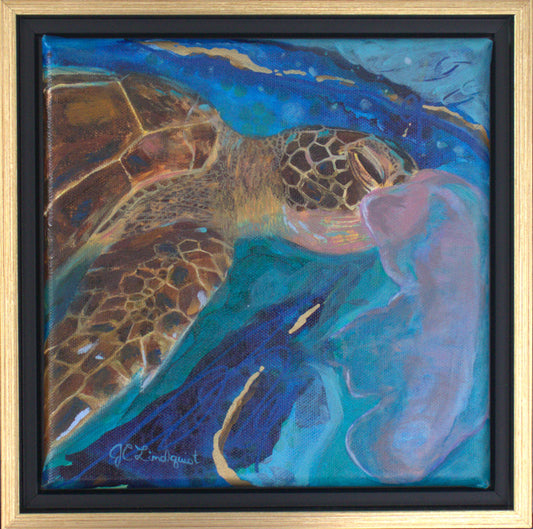 A framed painting of a brown sea turtle eating a jellyfish with an abstract blue background.