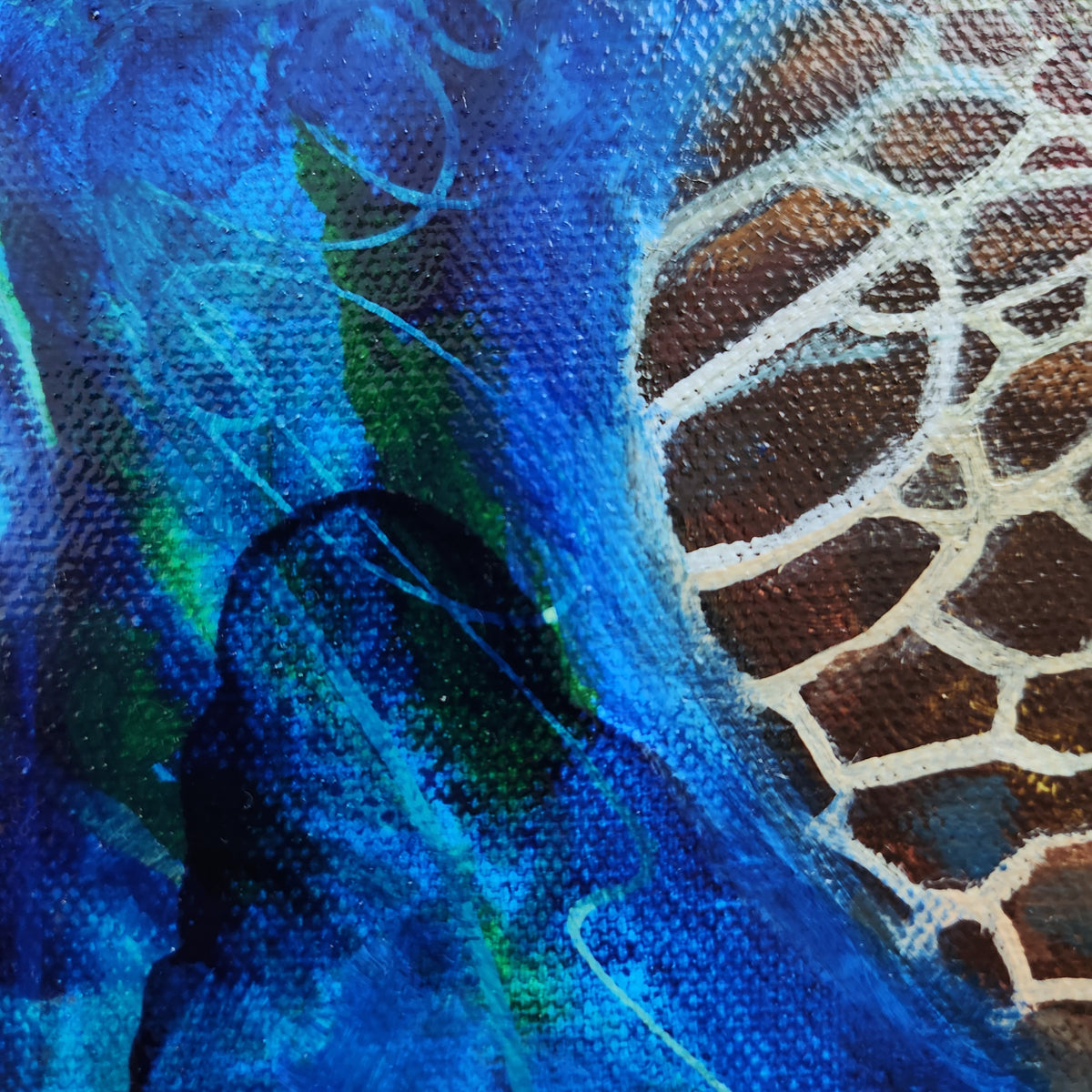Close-up of an abstract painting featuring textured blue and green brushstrokes alongside a brown and beige giraffe pattern.